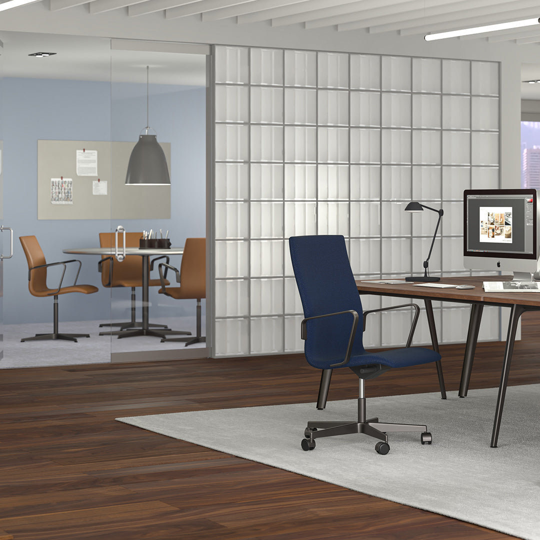 Modern office with blue and tan accents, patterned wood flooring, and a gray area rug against a light wall backdrop.