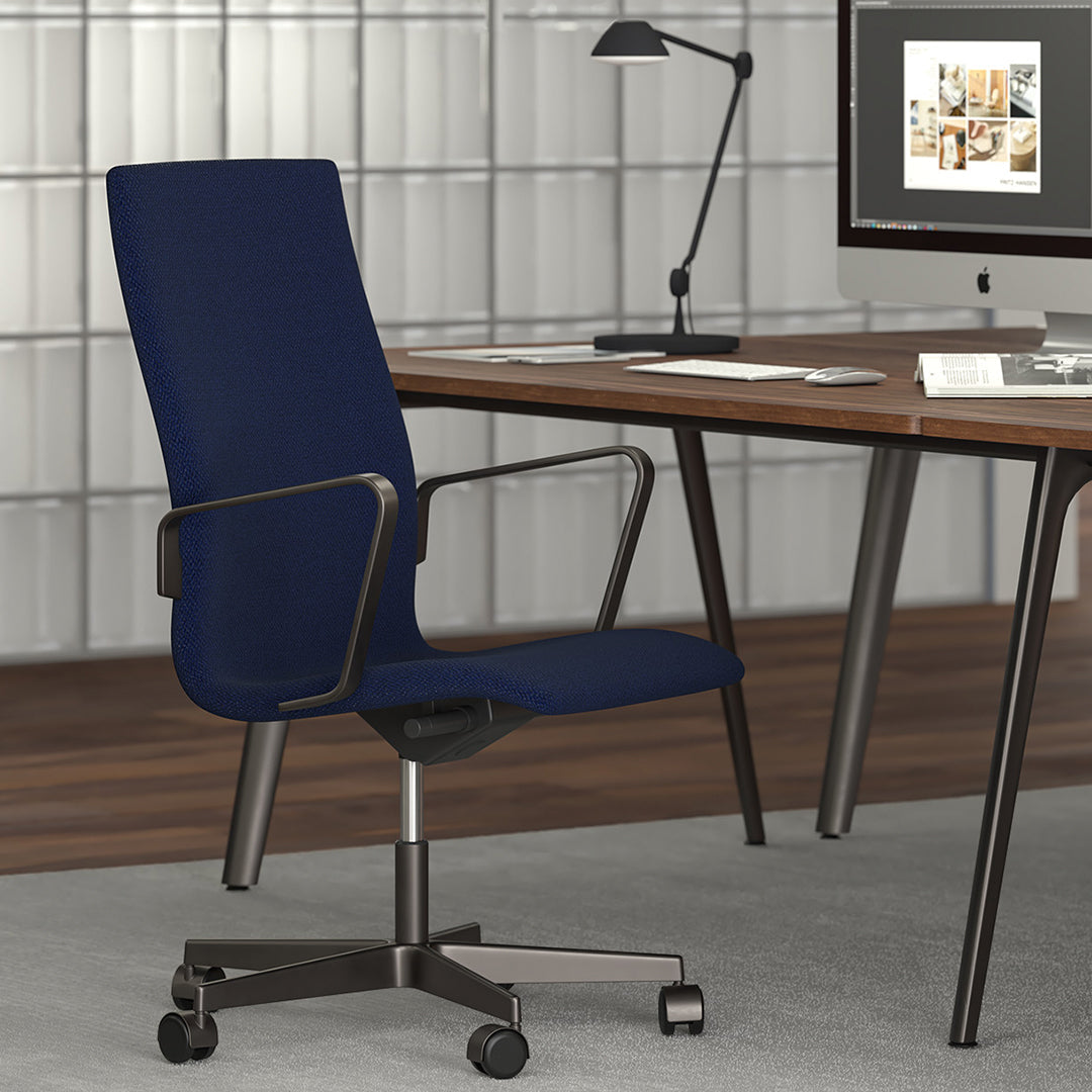 Navy blue upholstered office chair with sleek metal accents, set against a modern workspace backdrop.