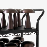 "Brown ceramic mushroom-shaped lamps on a sleek black metal cart."