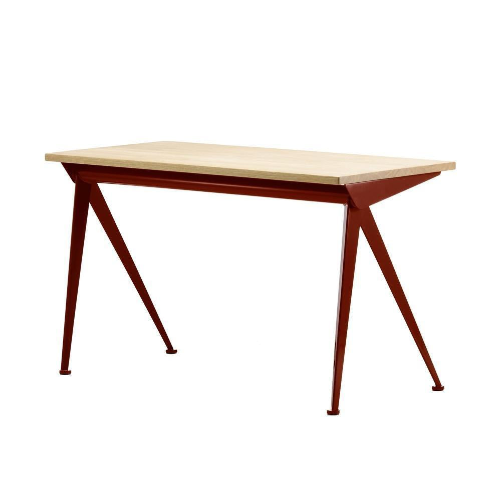 Modern rectangular table with a light wood top and rich red metal legs, featuring a sleek industrial design.