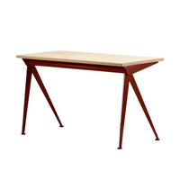 Modern rectangular table with a light wood top and rich red metal legs, featuring a sleek industrial design.
