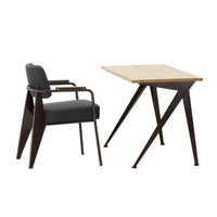 Modern black chair with gray upholstery and a natural wood tabletop on a sleek, dark metal base.