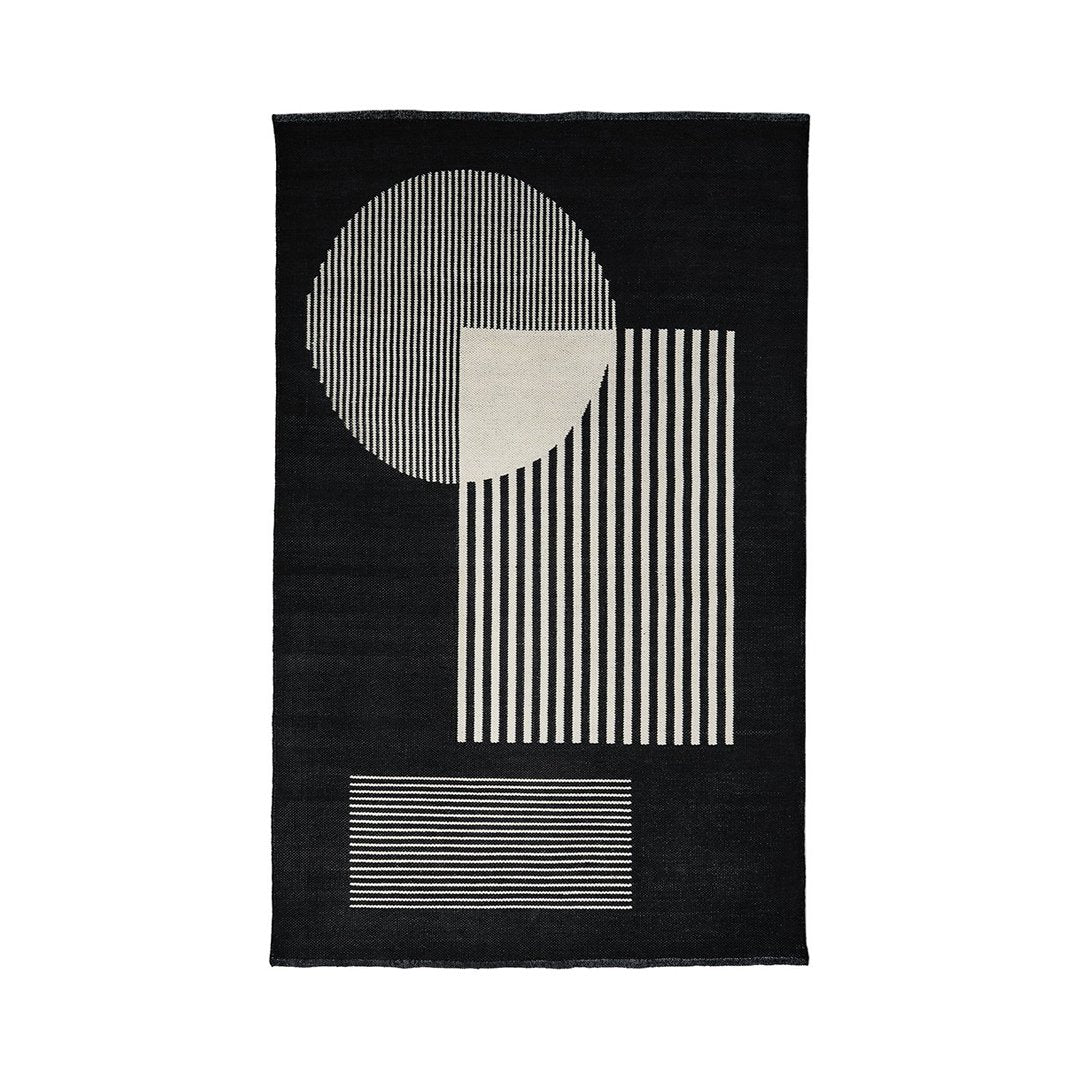 Black rug featuring geometric patterns in white, including stripes and circles for a modern, minimalist style.