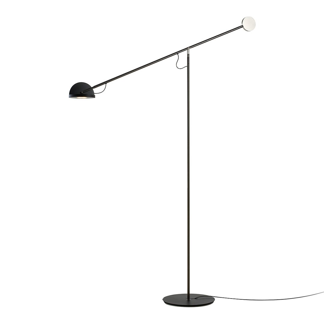 Modern black and white floor lamp with a sleek, minimal design and geometric shapes.