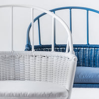"White and blue woven lounge chairs with curved backs and soft cushions showcasing modern design and vibrant colors."