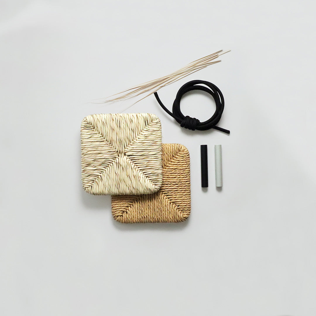 Natural woven coasters in beige and light brown, featuring textured patterns, with black and white accessories on a gray background.