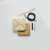 Natural woven coasters in beige and light brown, featuring textured patterns, with black and white accessories on a gray background.