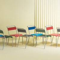 Colorful modern chairs in red, blue, green, and gray, featuring a sleek design and stylish patterns on seats.