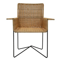 Natural woven rattan chair with a minimalist black metal frame, showcasing a textured pattern in earthy tones.