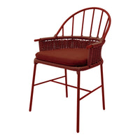 Red woven chair with a sleek design and a matching cushion, featuring a minimalistic pattern and elegant lines.