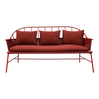 Red metal sofa with deep red cushions, featuring a sleek, modern design and minimalist pattern. Perfect for outdoor spaces.