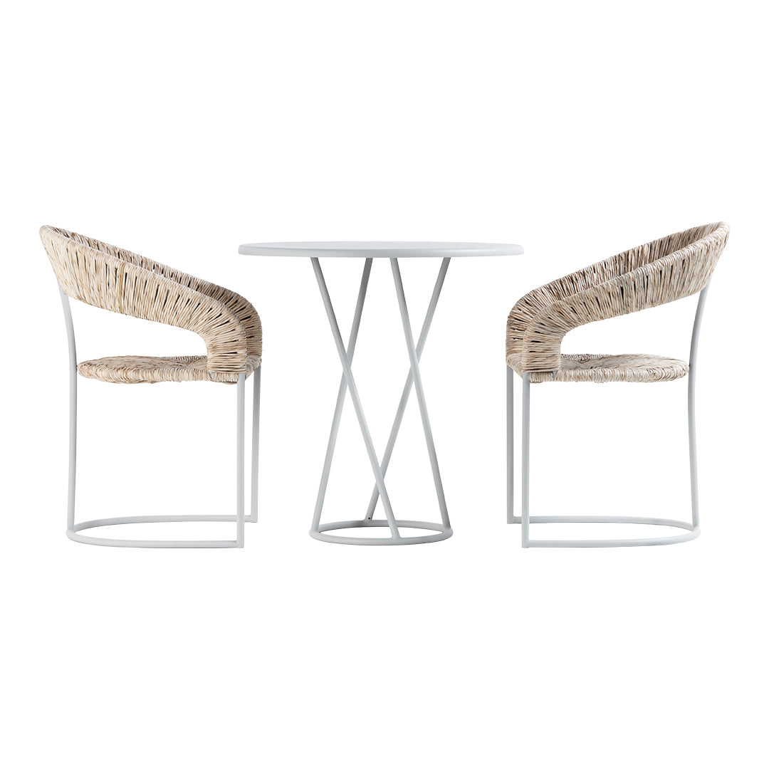 Boho-chic dining set featuring beige woven chairs and a sleek white round table with modern metal legs.