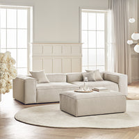 Neutral beige sectional sofa with soft fabric, paired with a round white rug and minimalist decor. Stylish and modern design.