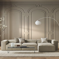 Beige sectional sofa with light gray and cream pillows, set against a textured beige wall, enhancing a modern, elegant look.