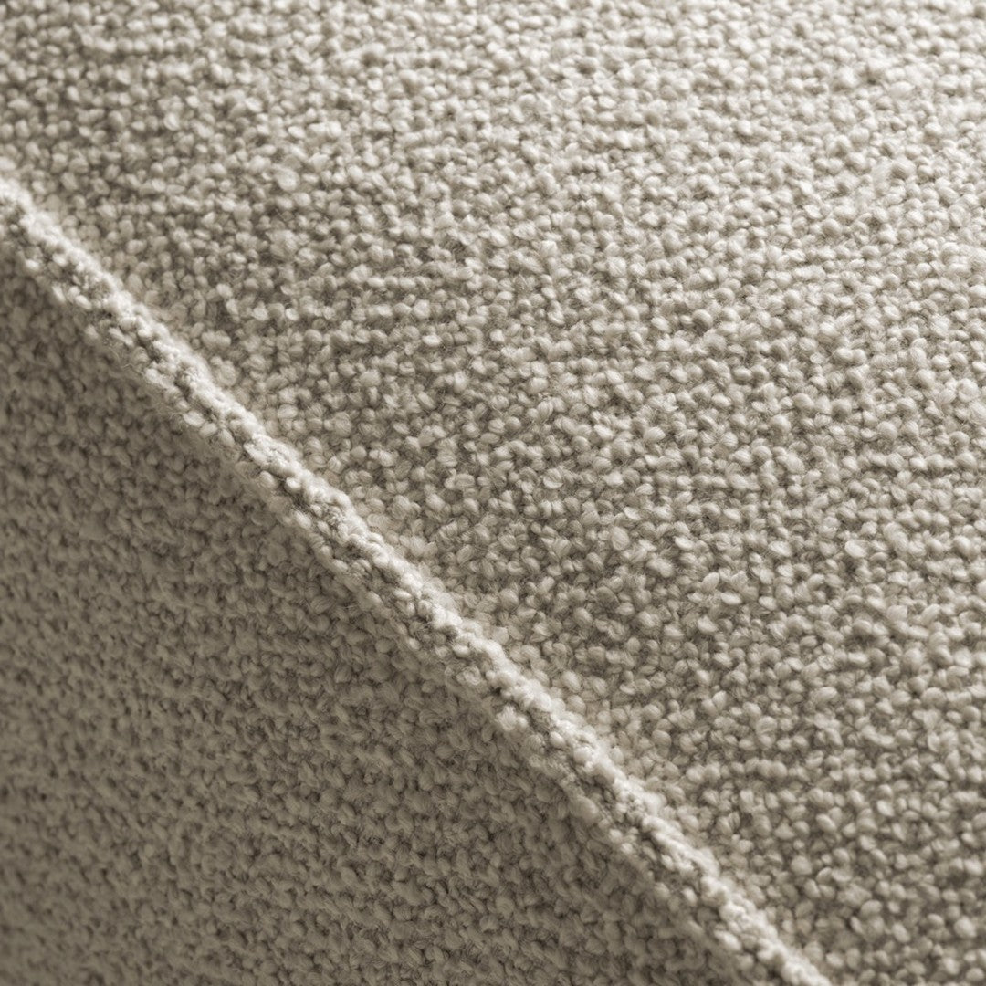 Textured beige fabric with a subtle, soft pattern and light color variations, ideal for modern decor.