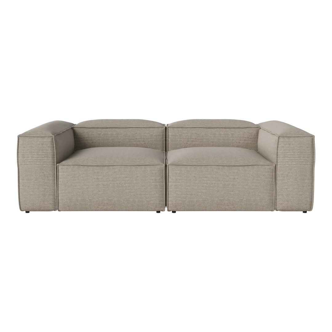 Beige modular sofa with a smooth textured fabric and clean, modern lines, perfect for contemporary living spaces.