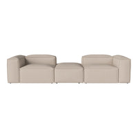 Beige modular sofa with a sleek, minimalistic design, featuring smooth, solid fabric upholstery and clean lines.