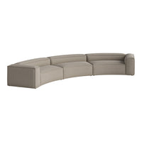 Curved sectional sofa in soft beige fabric with a subtle textured pattern, perfect for modern living spaces.