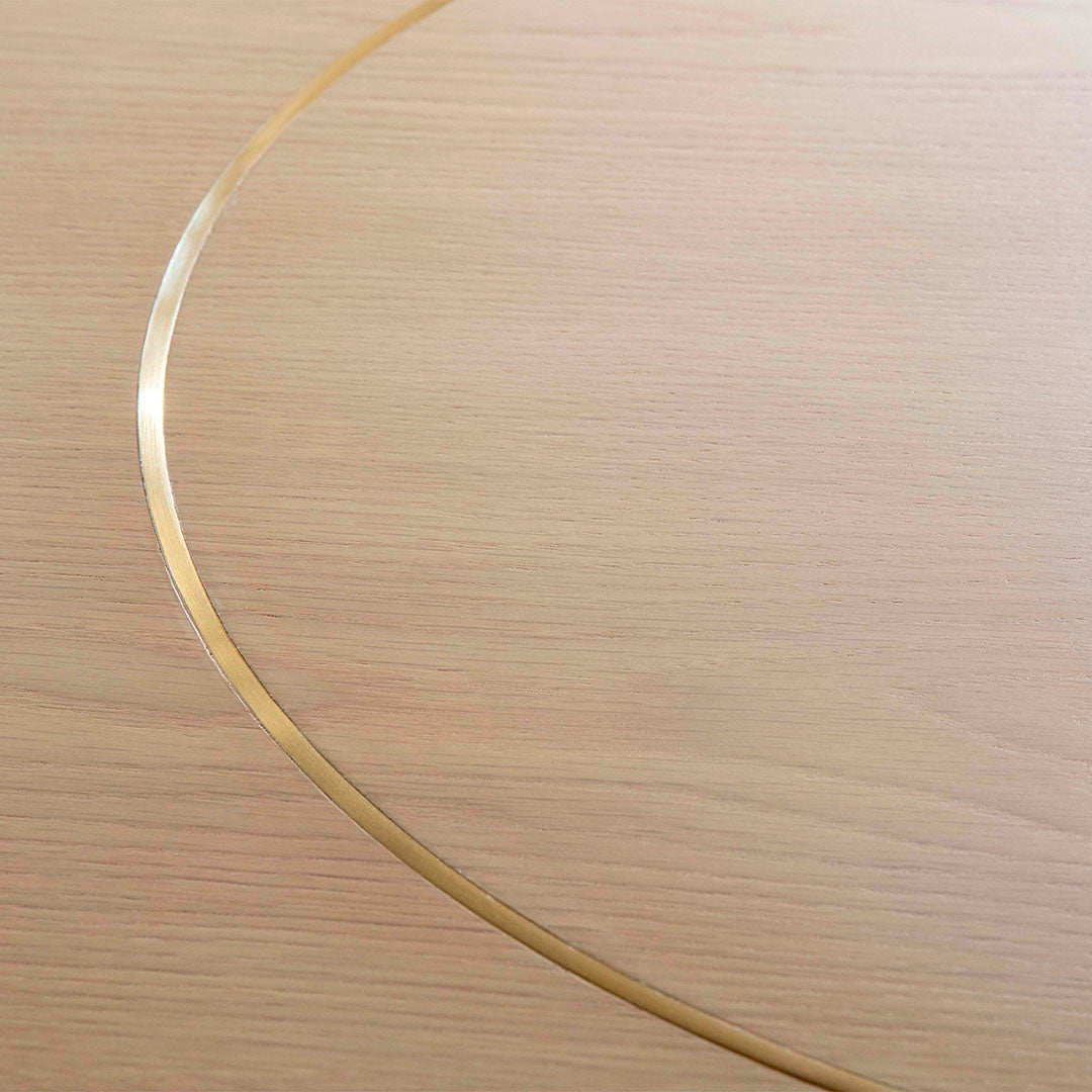 Light wood texture with a subtle golden metallic line creating an elegant curved pattern.