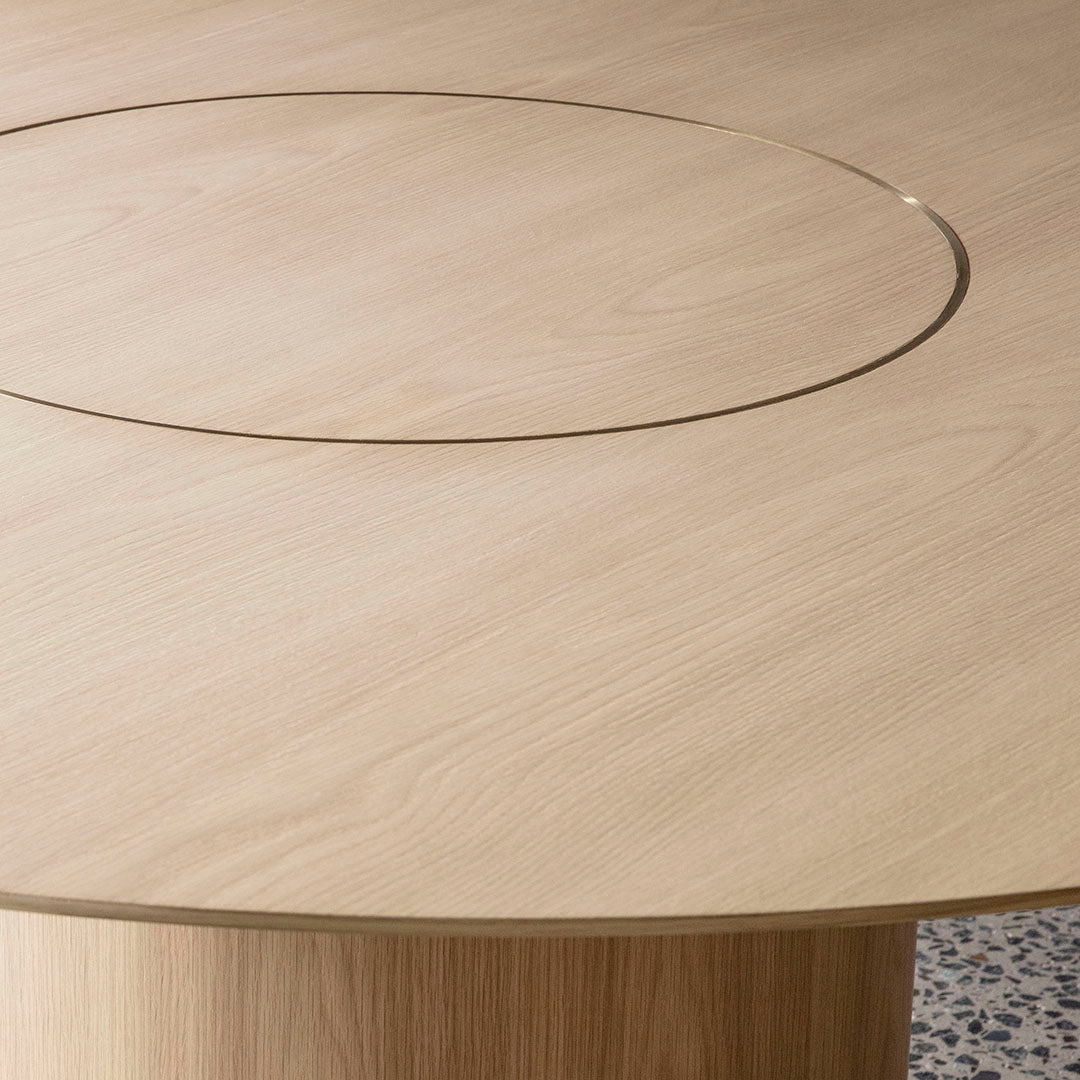 Light oak wood tabletop with a smooth grain and a subtle gold circular inlay detail.