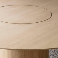 Light oak wood tabletop with a smooth grain and a subtle gold circular inlay detail.