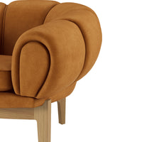 Textured rust-orange accent chair with rounded armrests and wooden legs, adding warmth and modern style to any space.