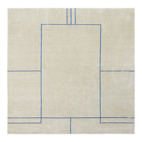 Beige linen rug with geometric blue pattern, featuring outlined rectangles and straight lines.