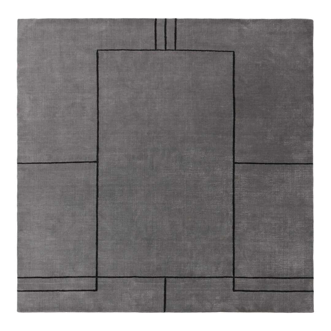 Gray rug with a geometric black pattern, featuring clean lines and modern design elements. Perfect for contemporary spaces.