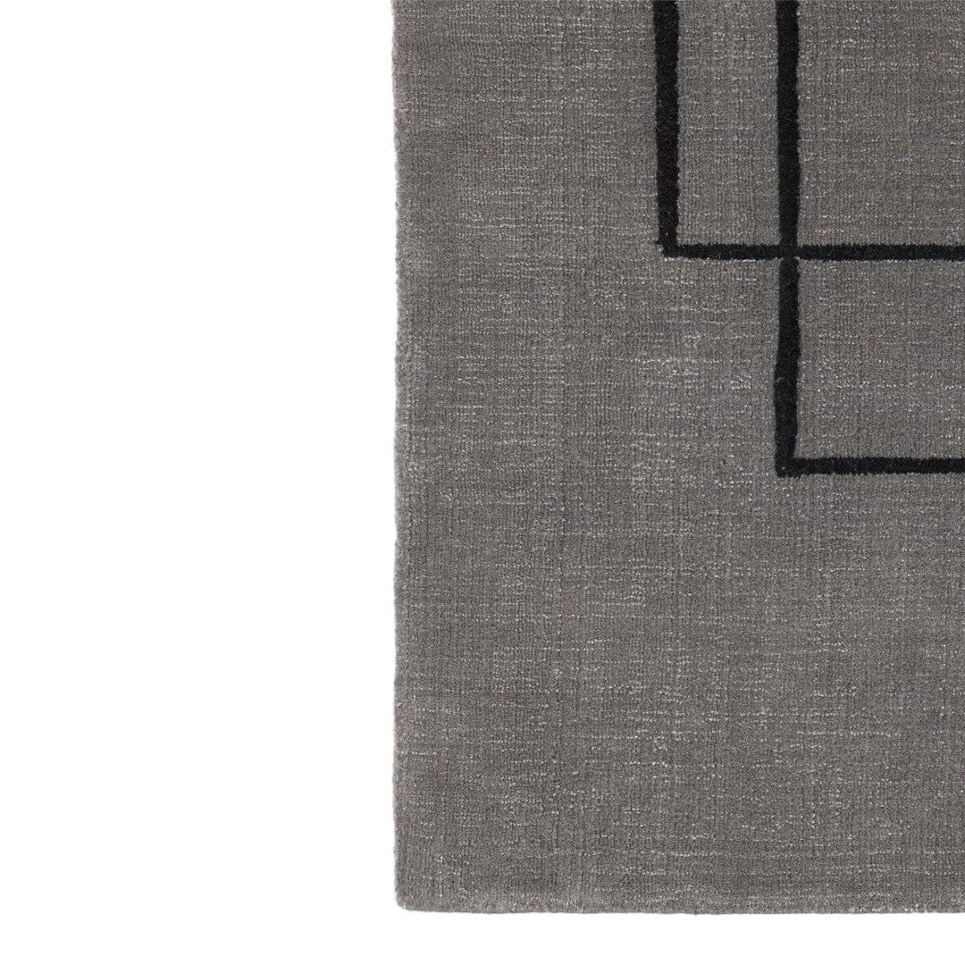 Gray area rug featuring a minimalist black geometric pattern. Perfect for modern decor.