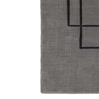 Gray area rug featuring a minimalist black geometric pattern. Perfect for modern decor.
