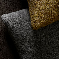Close-up of textured fabric in dark gray, rich brown, and vibrant mustard yellow. Perfect for modern decor accents.