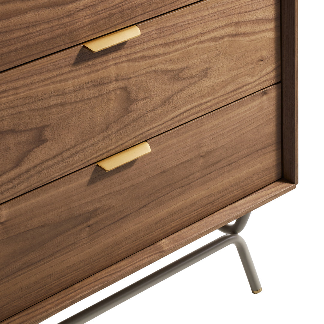 Wooden drawer unit in rich walnut finish with sleek gold handles and a modern metal base.