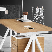 Modern desk with a light wood finish, white accents, and minimalistic black and gray organizational elements.