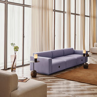 "Light lavender sofa with a smooth texture, paired with earthy brown accents and neutral-toned decor."