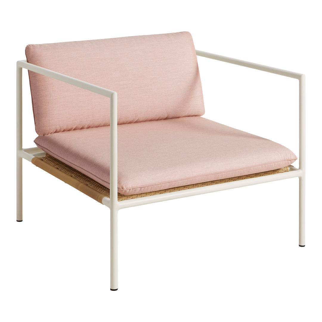 Pink cushioned armchair with a white metal frame and natural wood base, featuring minimalist design and soft tones.