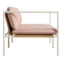 Modern two-tone sofa in soft pink upholstery and natural woven accents on a sleek white frame. Perfect for stylish decor.