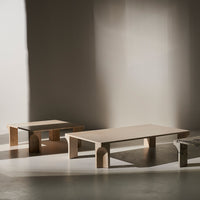 Minimalist wooden coffee tables in natural tones with sleek, smooth finishes and geometric shapes.