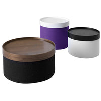 Round storage containers in black, purple, white, and wood finish, featuring smooth, modern patterns and contrasting colors.