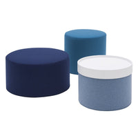 "Set of three upholstered stools in navy, teal, and light blue with smooth and textured finishes."