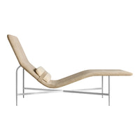 Beige chaise lounge with a sleek, modern design and minimalist metallic frame. Soft texture complements contemporary decor.