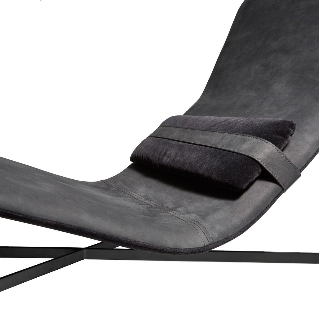 Sleek black leather lounge chair with smooth curves and a plush, contrasting cushion for added comfort.