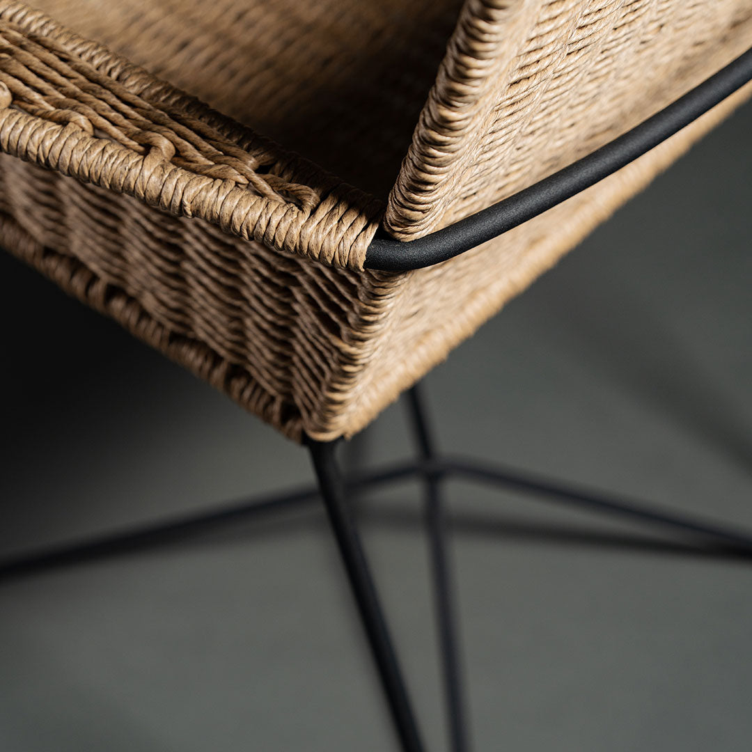 "Natural woven tan seat with black metal frame, showcasing a modern, minimalist design."