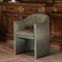 Olive green upholstered armchair with a ribbed texture, featuring a smooth and modern curved design.