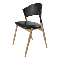 Black chair with a sleek curved back and natural wood legs, showcasing a modern design with a minimalist aesthetic.