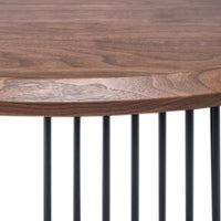 Walnut wood tabletop with natural grain patterns and black metal rods, creating a modern, stylish contrast.