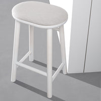 Light gray upholstered stool with a sleek white frame, set on a gray surface. Modern and minimalist design.