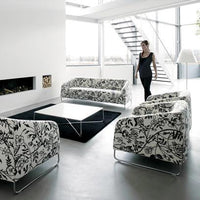 Black and white floral patterned sofas in a contemporary living space with minimalist decor.