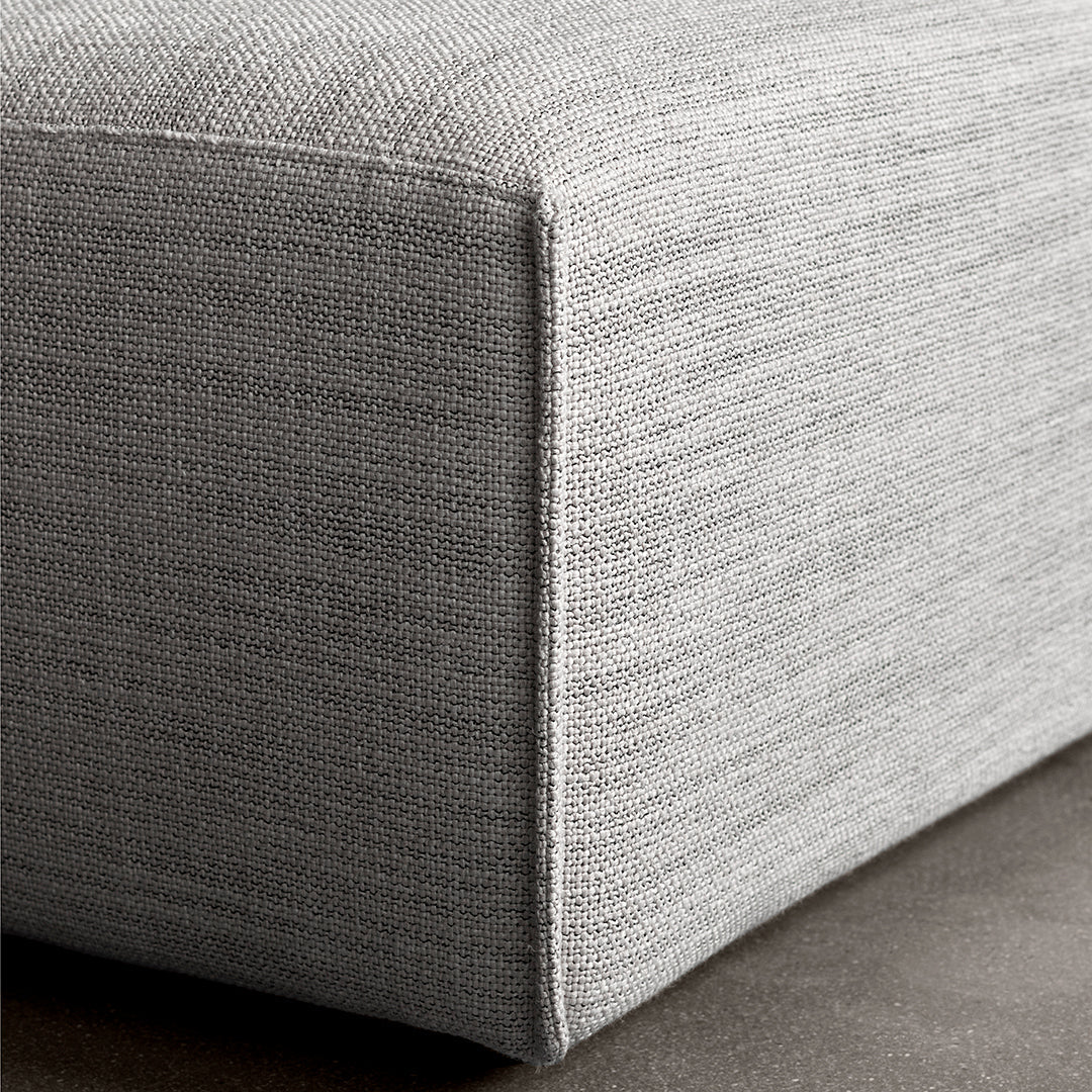 Light gray textured fabric with subtle woven pattern, showcasing a modern and minimalist design.