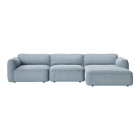 Soft blue sectional sofa with a modern design, featuring sleek lines and versatile, removable cushions.