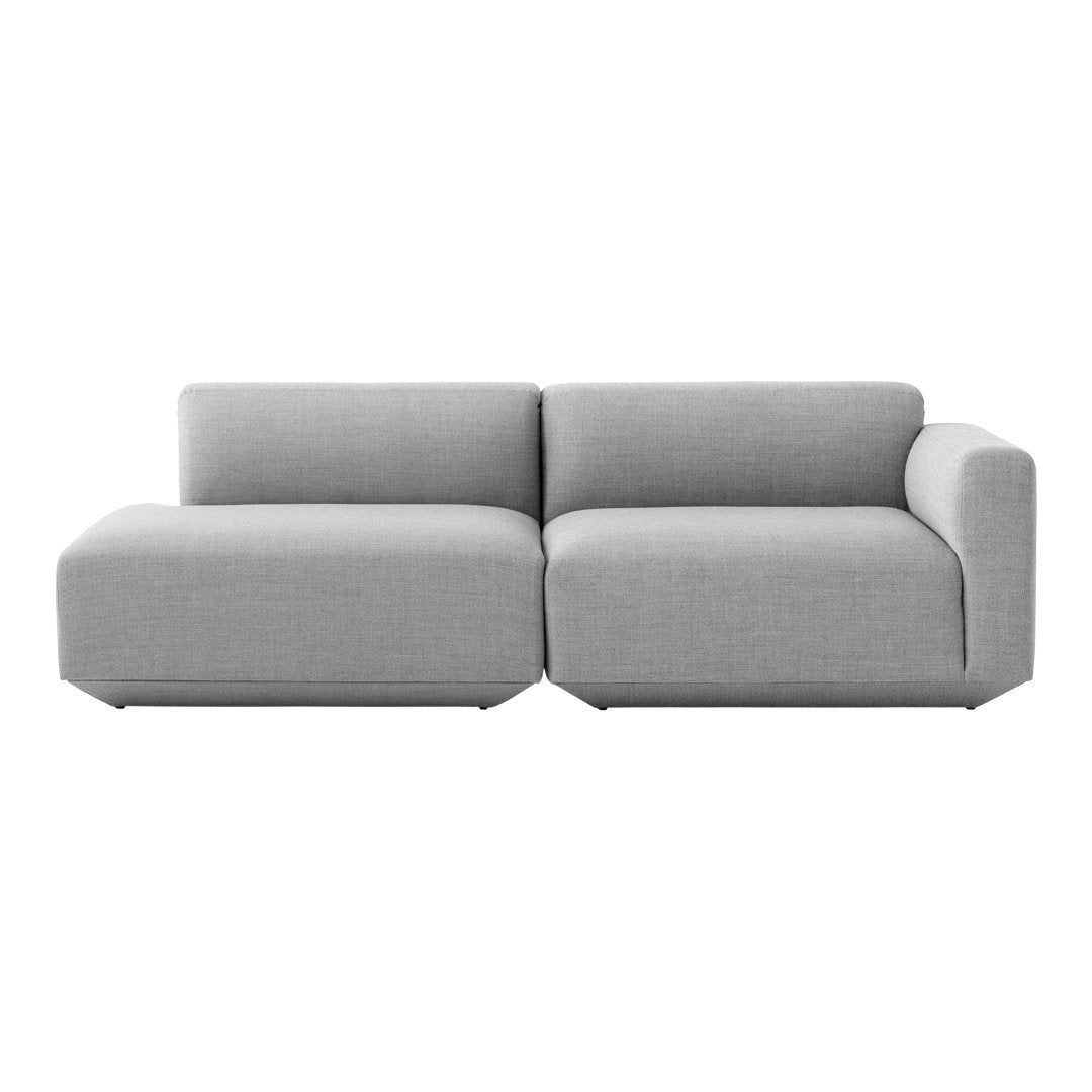 Modern sectional sofa in a soft light gray fabric with a sleek, minimalist design and no visible patterns.